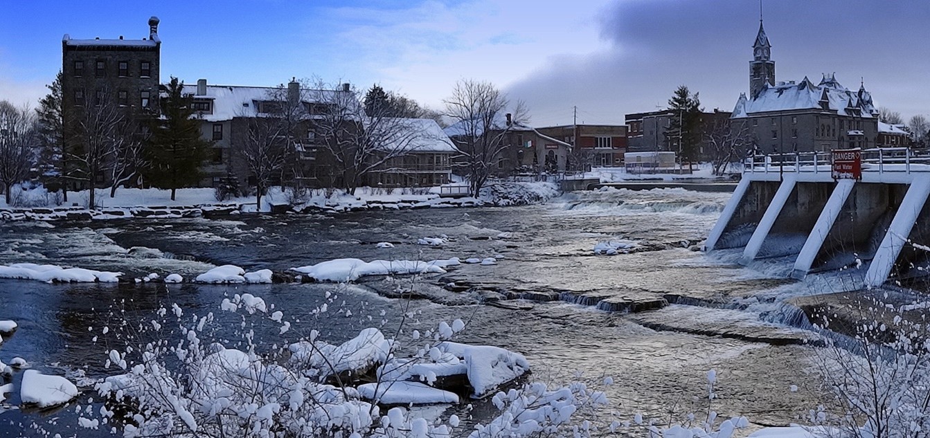 Image of the dam in Carleton Place in the winter with Town Hall in the background