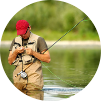 Man fly fishing and tying a lure