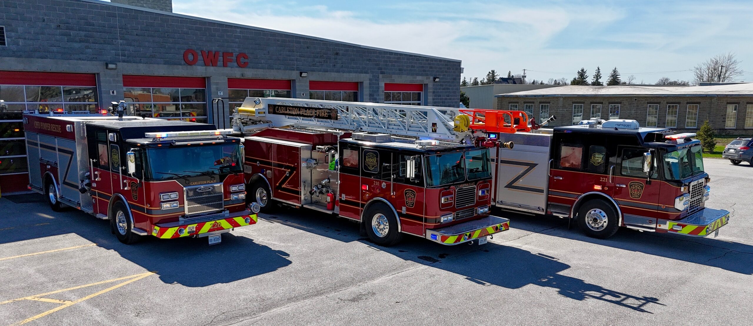 three fire trucks parked on an angle
